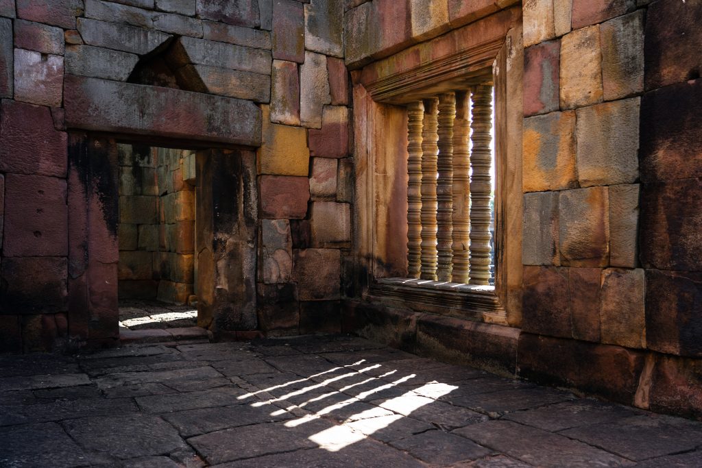 Ancient sandstone sanctuary with stone floor, wall and light through the stone window.