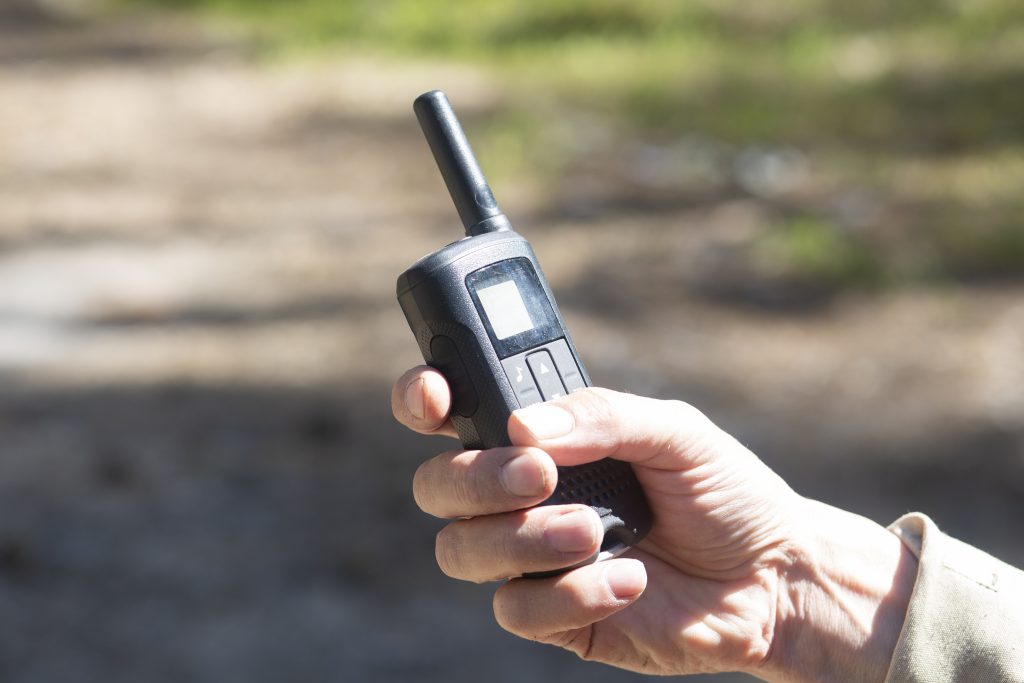 Walkie-talkies.Using walkie-talkies in the forest to transmit messages.